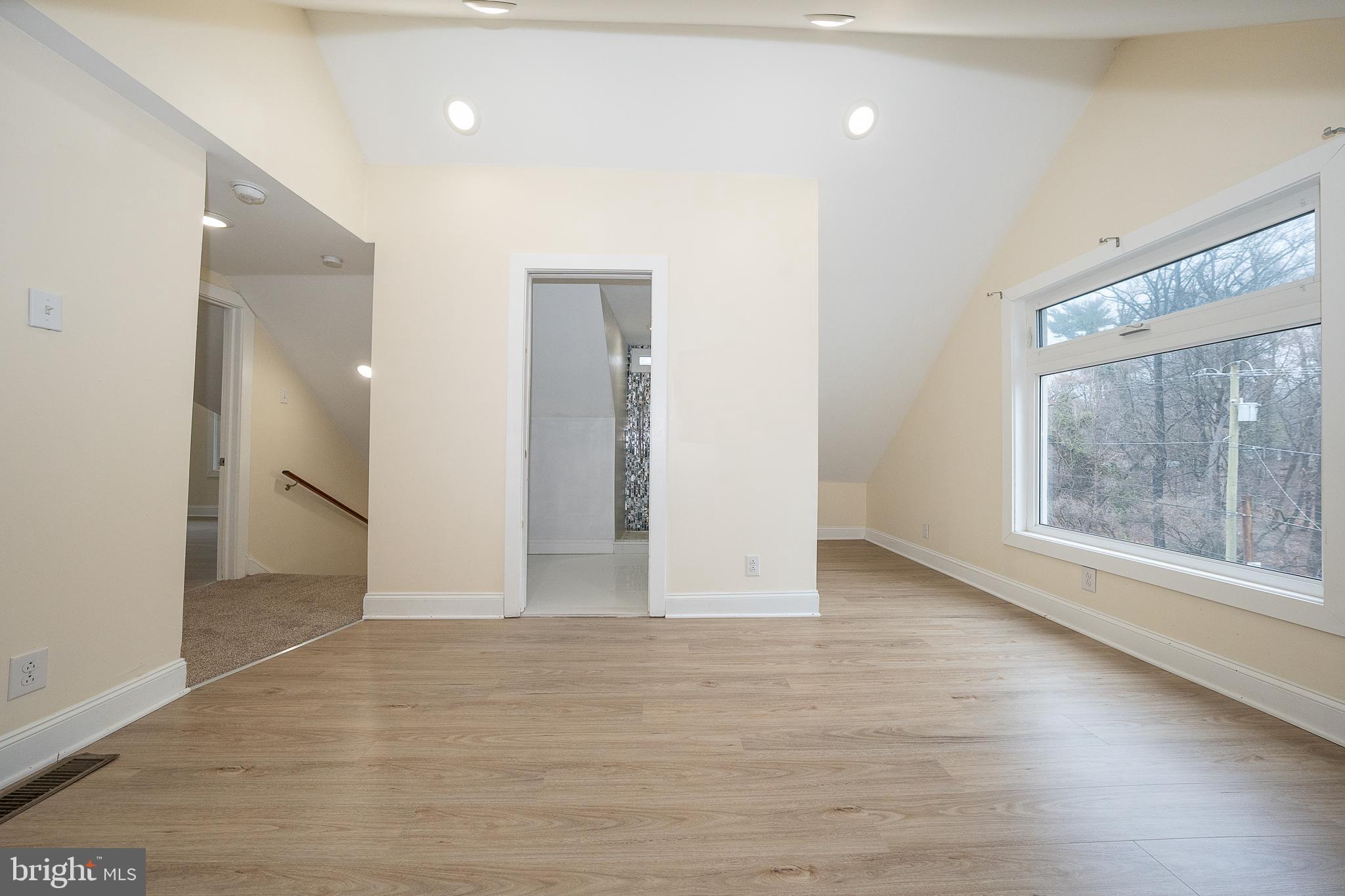 622 Spring Avenue Elkins Park, PA 19027 - Photo 47 of 65 a view of an empty room with wooden floor and a window