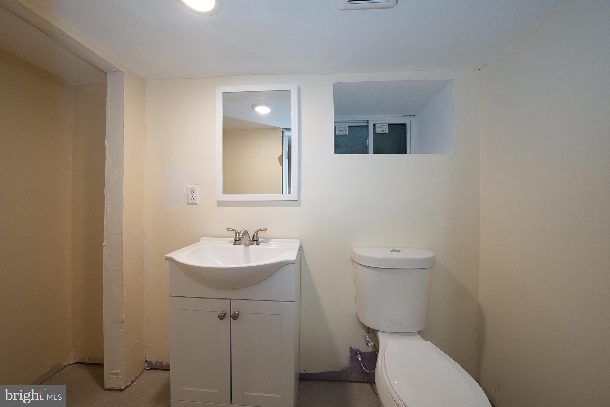 622 Spring Avenue Elkins Park, PA 19027 - Photo 59 of 65 a bathroom with a toilet a sink and mirror