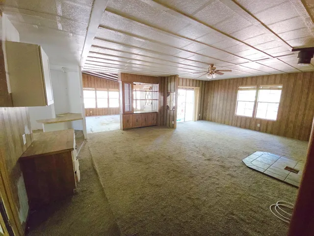a view of an empty room with a fireplace