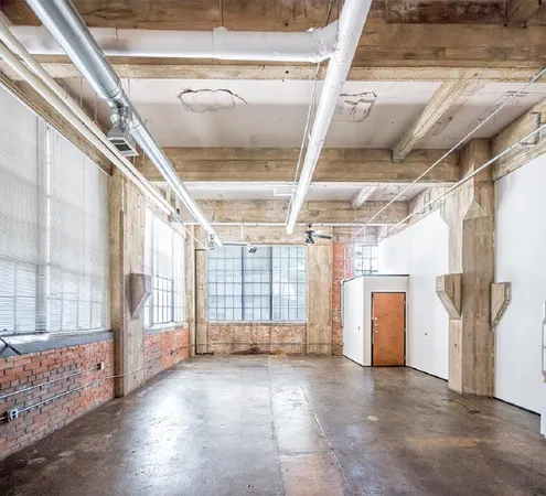 a view of an empty room with a fireplace
