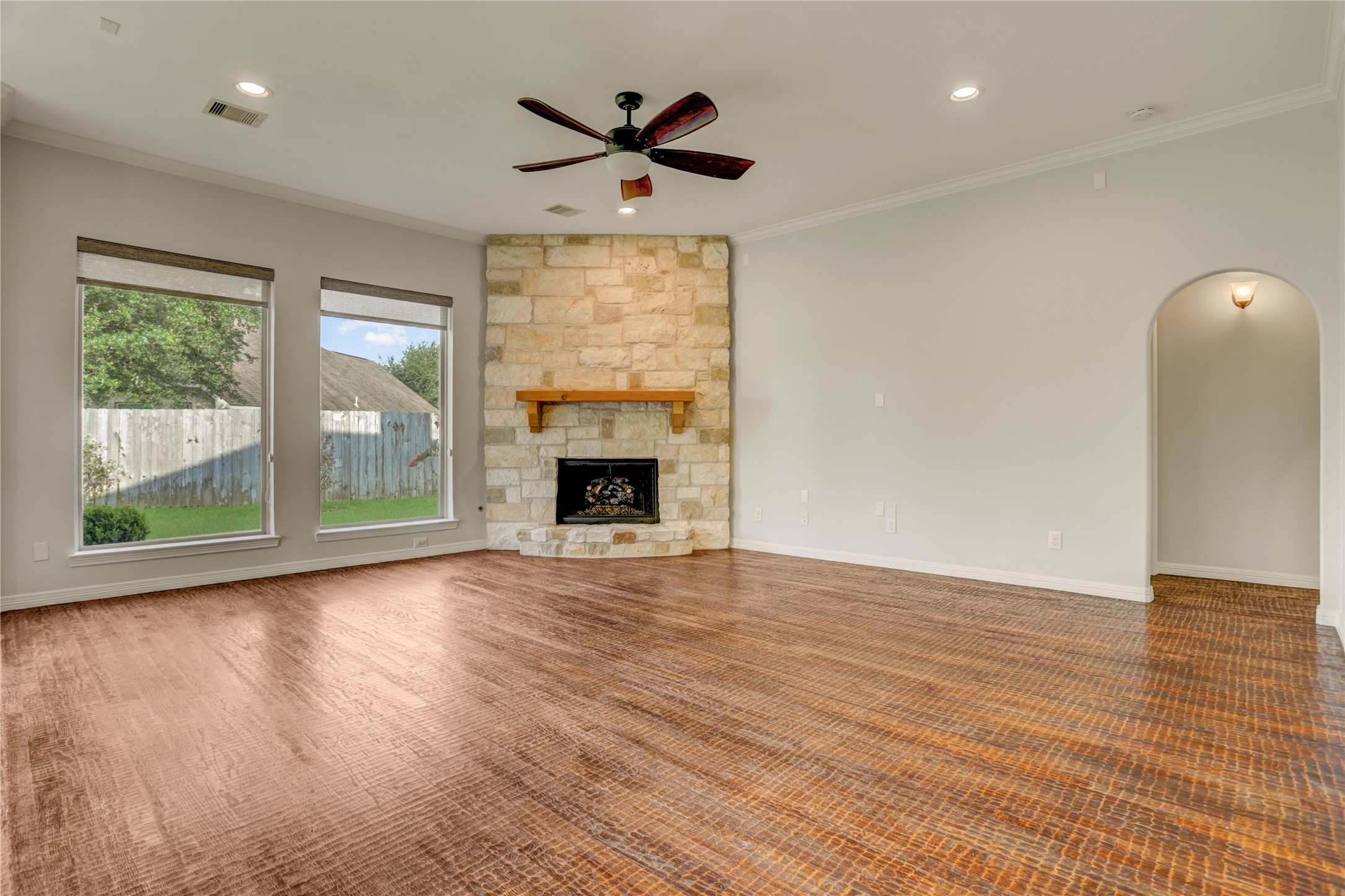 3002 Currant Drive Manvel, TX 77578 - Photo 15 of 43 an empty room with wooden floor a ceiling fan and windows
