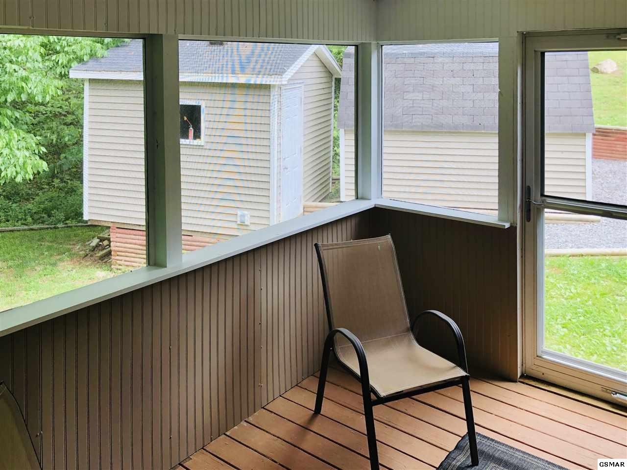 1403 Lin Creek Road Sevierville, TN 37876 - Photo 15 of 24 a view of a balcony with chair and table