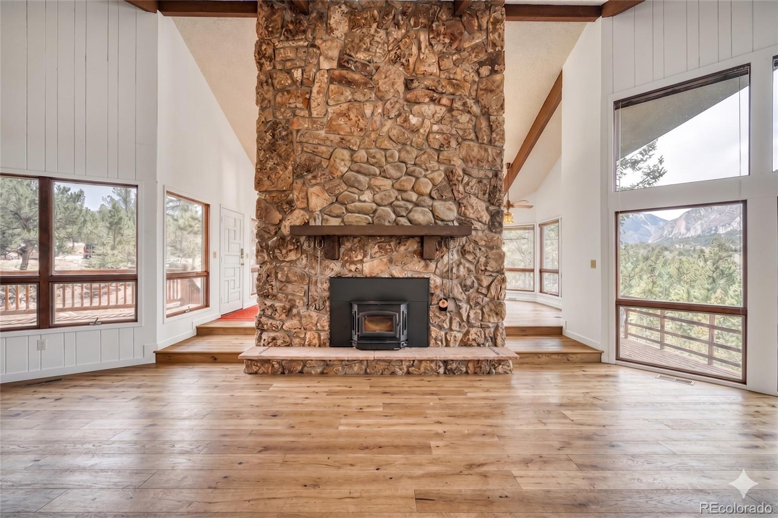 15351 Chimney Rock Road Nathrop, CO 81236 - Photo 21 of 48 a view of an empty room with wooden floor and a fireplace