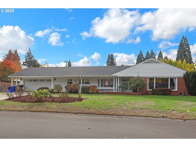 a front view of a house with a garden and pathway