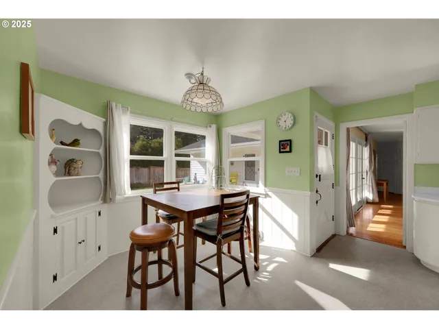 a view of a dining room with furniture and a chandelier