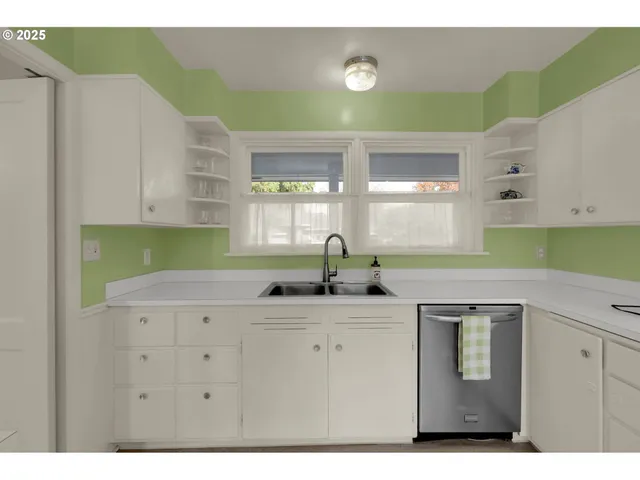 a kitchen with a sink cabinets and a window