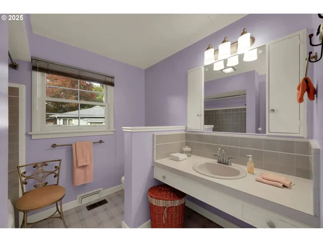 a bathroom with a sink vanity and a mirror