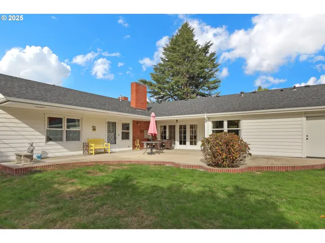 a view of house with yard and entertaining space