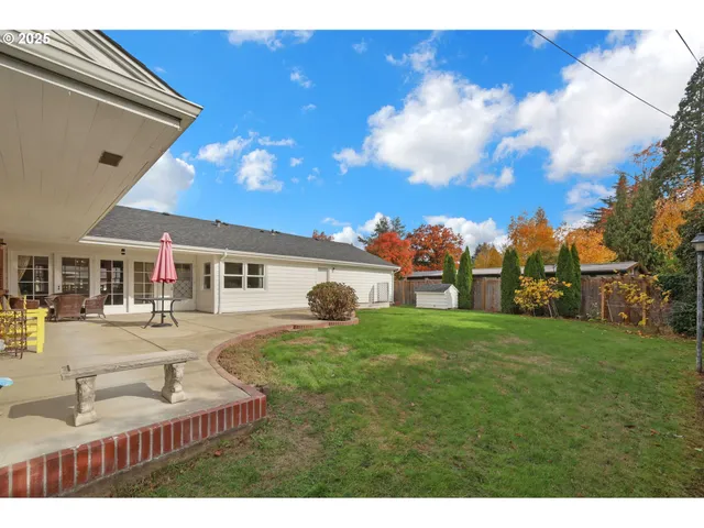 a view of a backyard with swimming pool