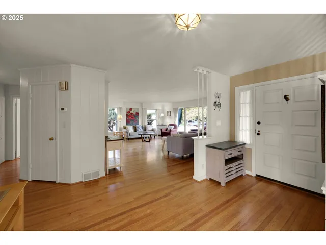 a view of kitchen and hall with wooden floor
