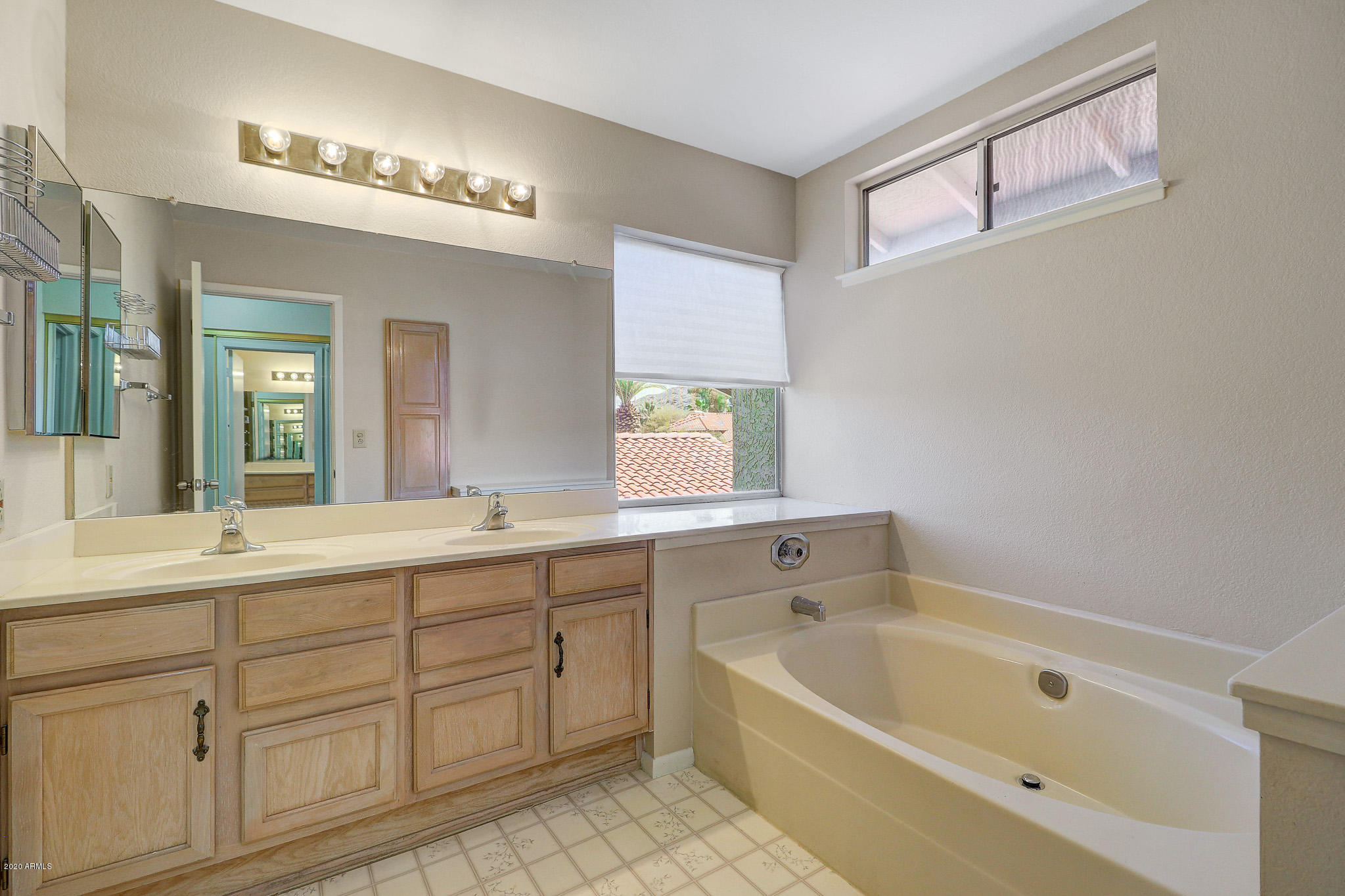 1902 East Redfield Road Phoenix, AZ 85022 - Photo 13 of 31 a bathroom with a tub a sink and mirror