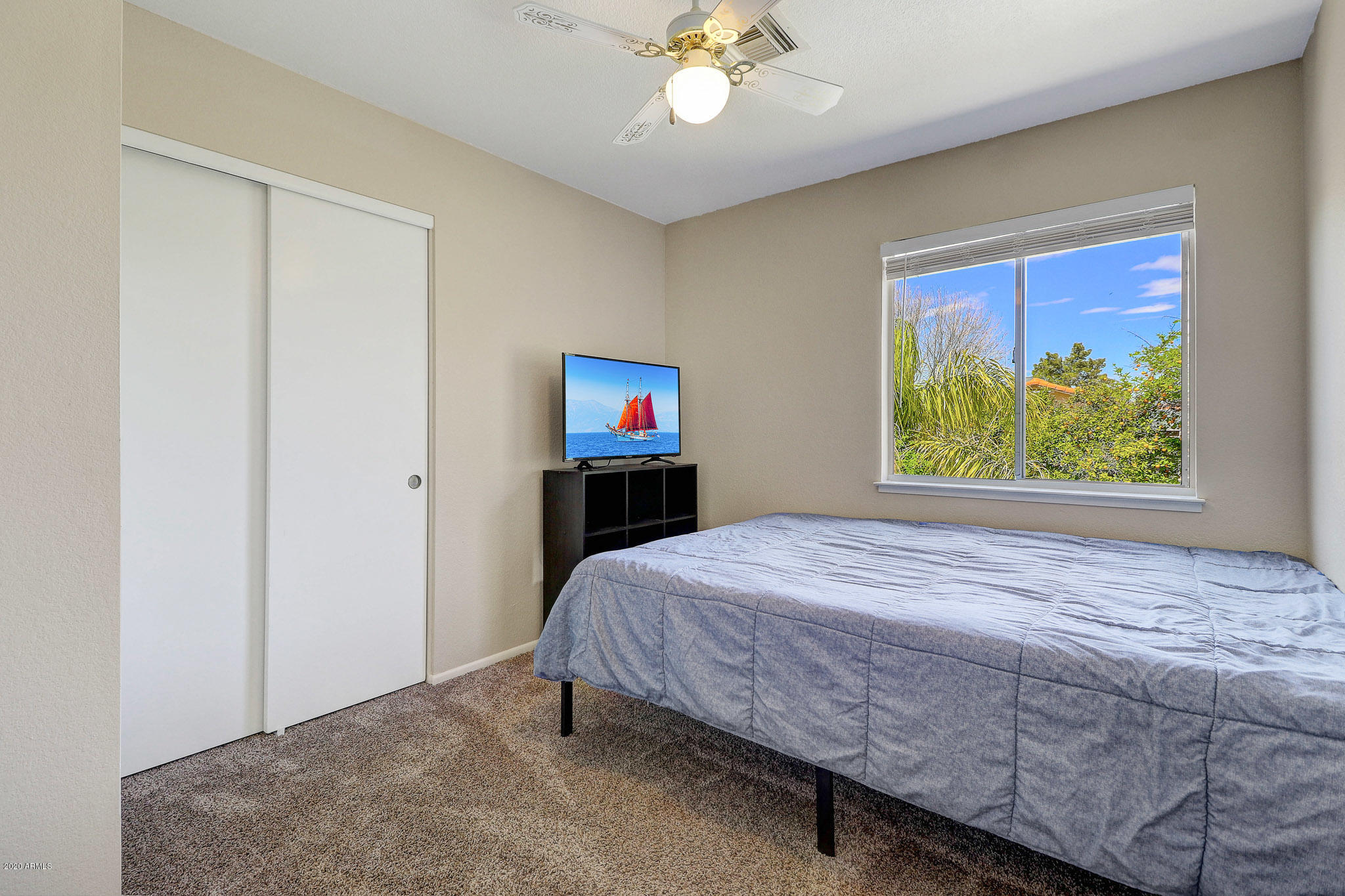 1902 East Redfield Road Phoenix, AZ 85022 - Photo 17 of 31 a bedroom with a bed and a chandelier