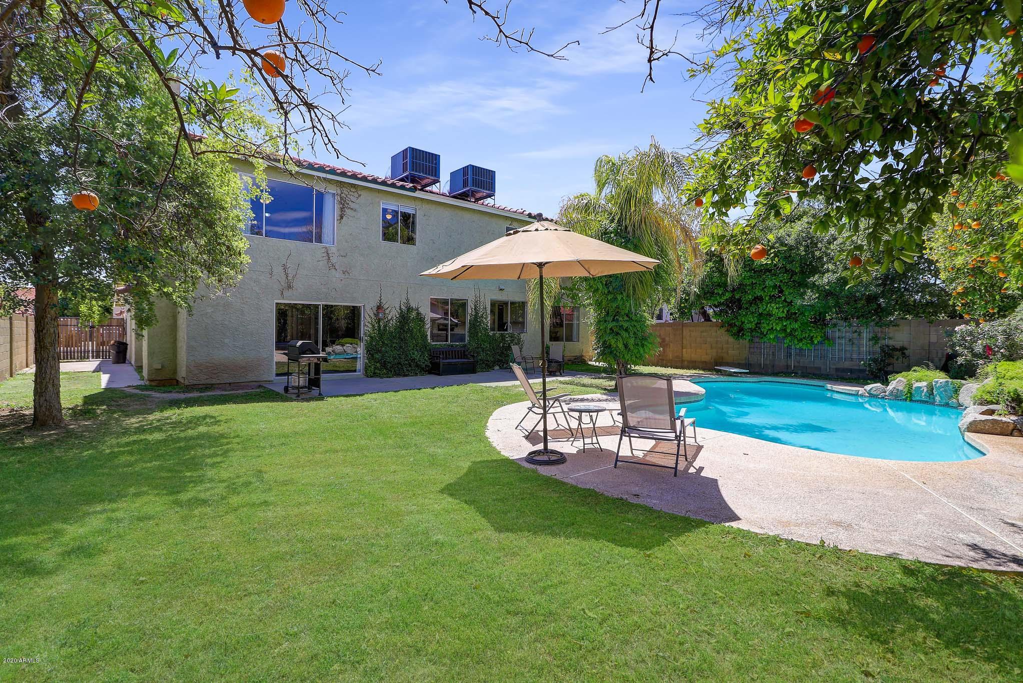 1902 East Redfield Road Phoenix, AZ 85022 - Photo 23 of 31 a view of a backyard with table and chairs under an umbrella