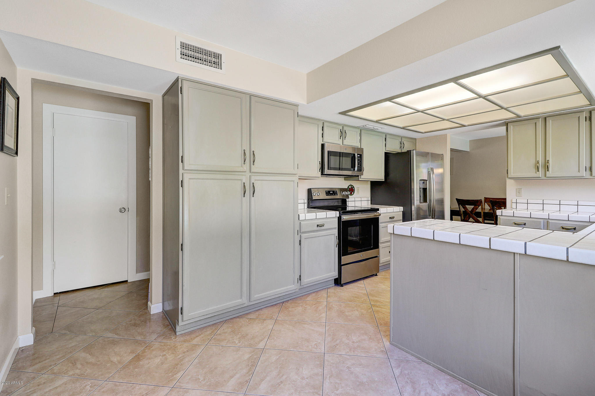 1902 East Redfield Road Phoenix, AZ 85022 - Photo 4 of 31 a kitchen with kitchen island a counter top space stainless steel appliances and cabinets
