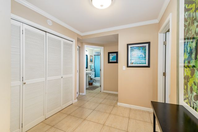 a bedroom with a bed and a dresser with bookshelf