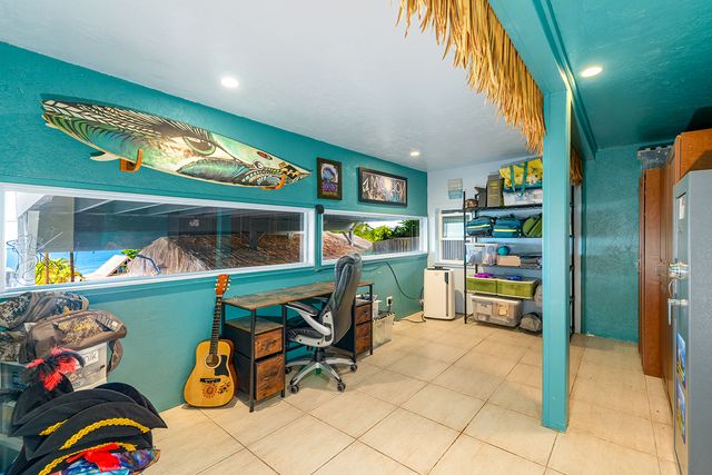 a front view of a house with plants