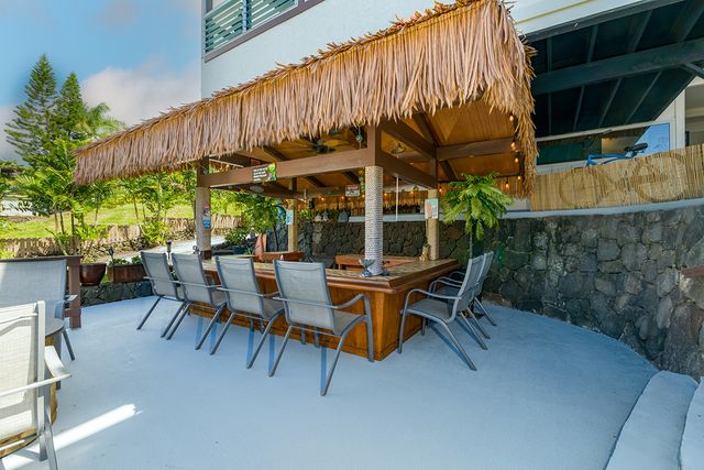 an aerial view of a house with garden space and sitting area