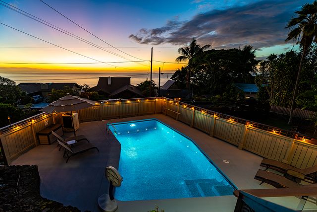 a view of a swimming pool with seating area