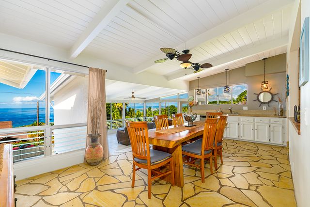 a dining hall with stainless steel appliances a dining table and chairs with wooden floor