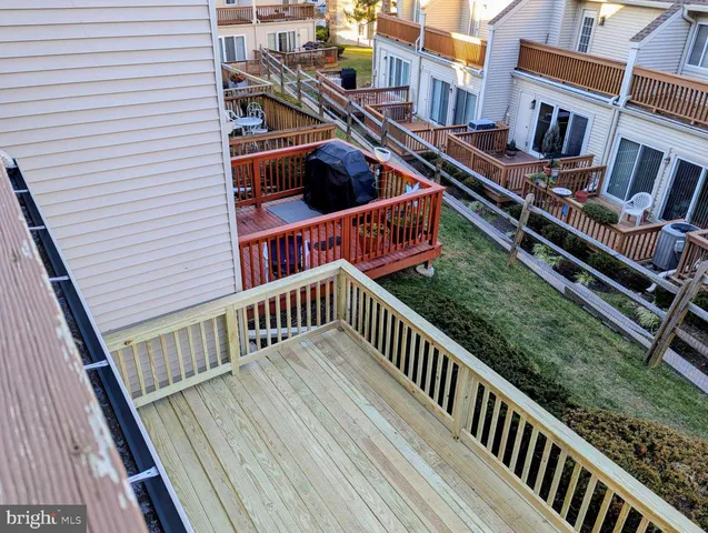 a view of balcony with wooden floor and fence and a deck