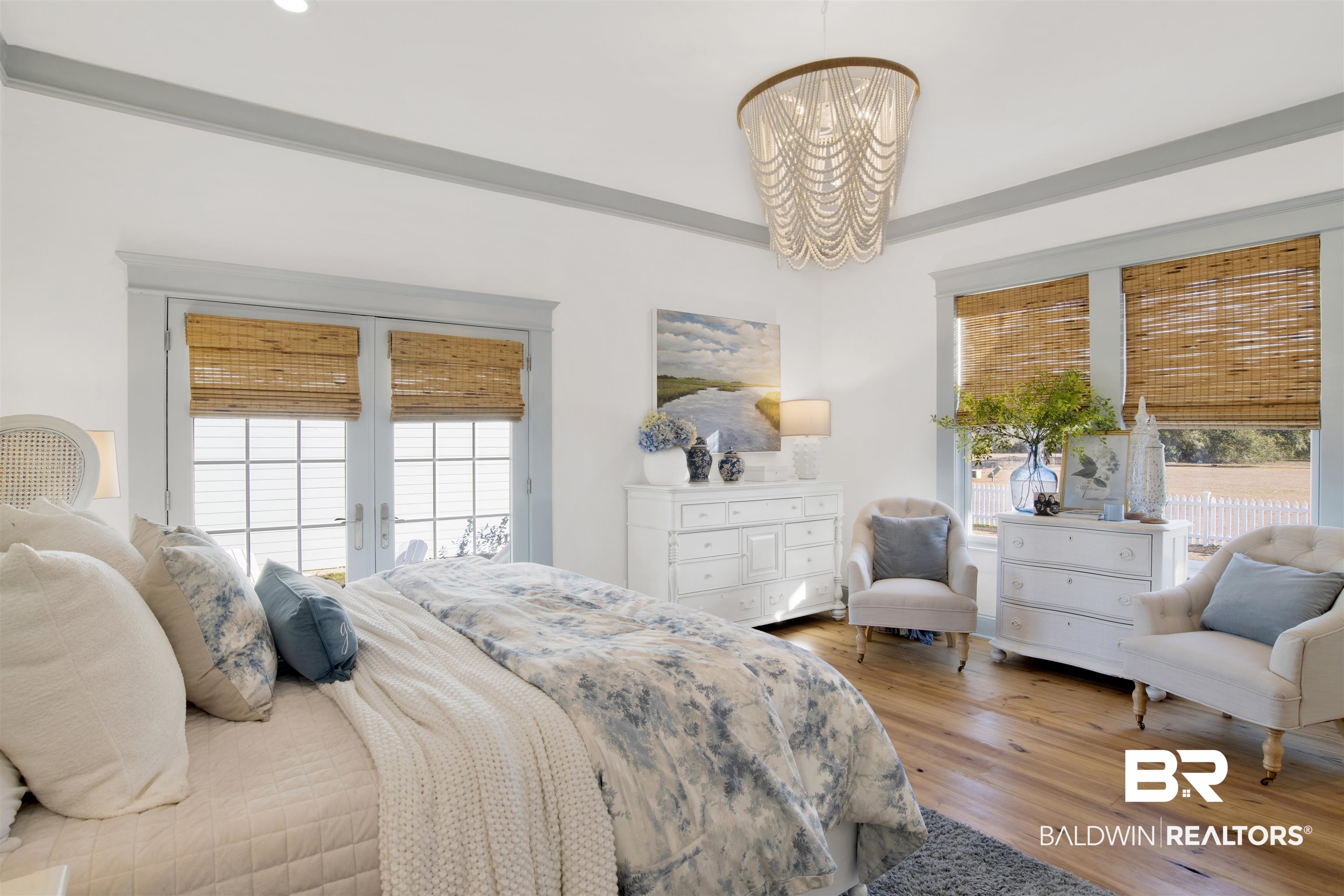 12094 Old Federal Road Magnolia Springs, AL 36555 - Photo 21 of 48 Bedroom featuring a notable chandelier, access to exterior, and light hardwood / wood-style floors