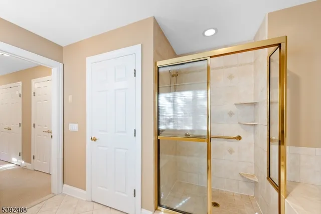 a bedroom with a bed and a flat tv screen on dresser