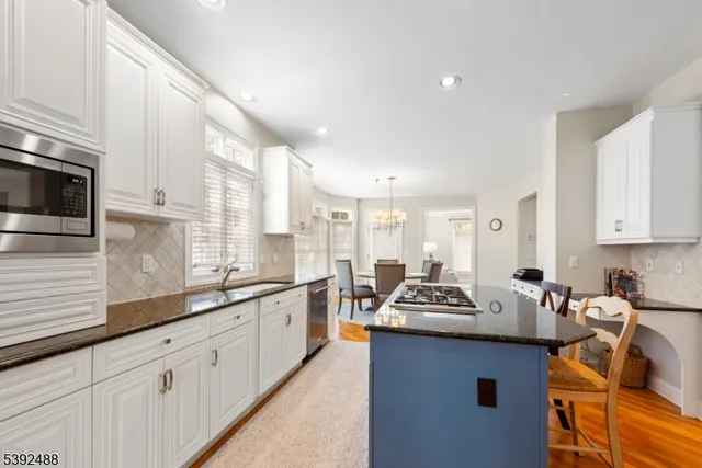 a view of a kitchen area with furniture and wooden floor