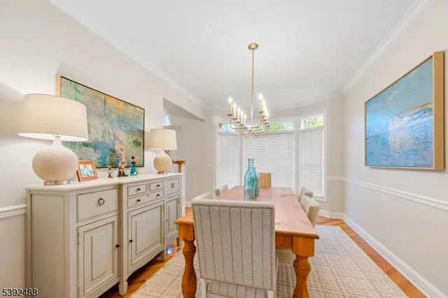 a dining room with furniture a chandelier and window