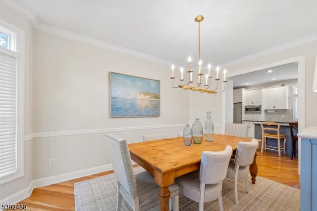 a dining room with furniture window and wooden floor
