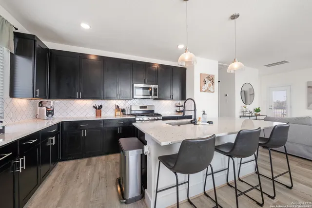 a view of a dining room with furniture and chandelier