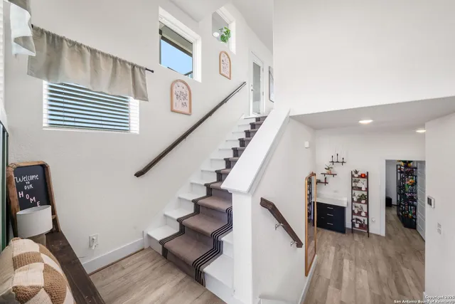 a view of entryway and hall with wooden floor