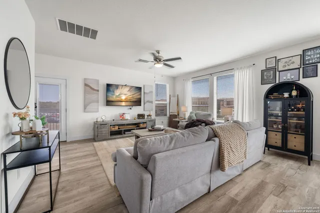 a living room with furniture a large window and a flat screen tv