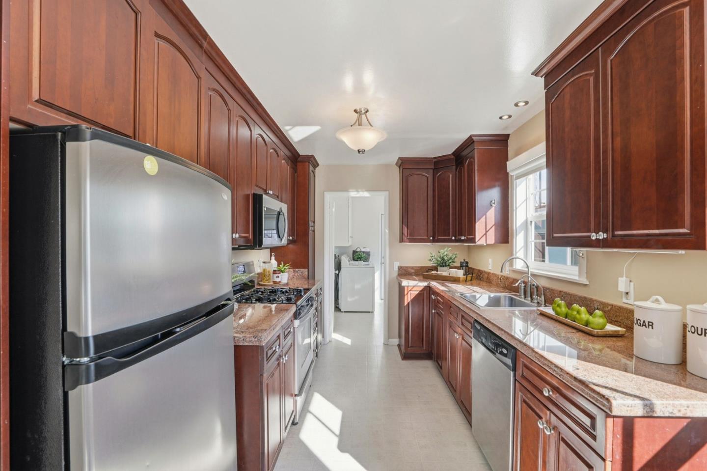 813 Cowper Street Palo Alto, CA 94301 - Photo 10 of 25 a kitchen with stainless steel appliances granite countertop a sink stove and refrigerator