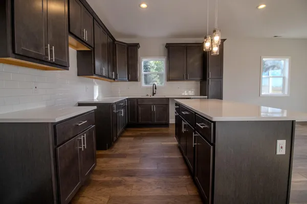 a kitchen with stainless steel appliances a sink stove and cabinets
