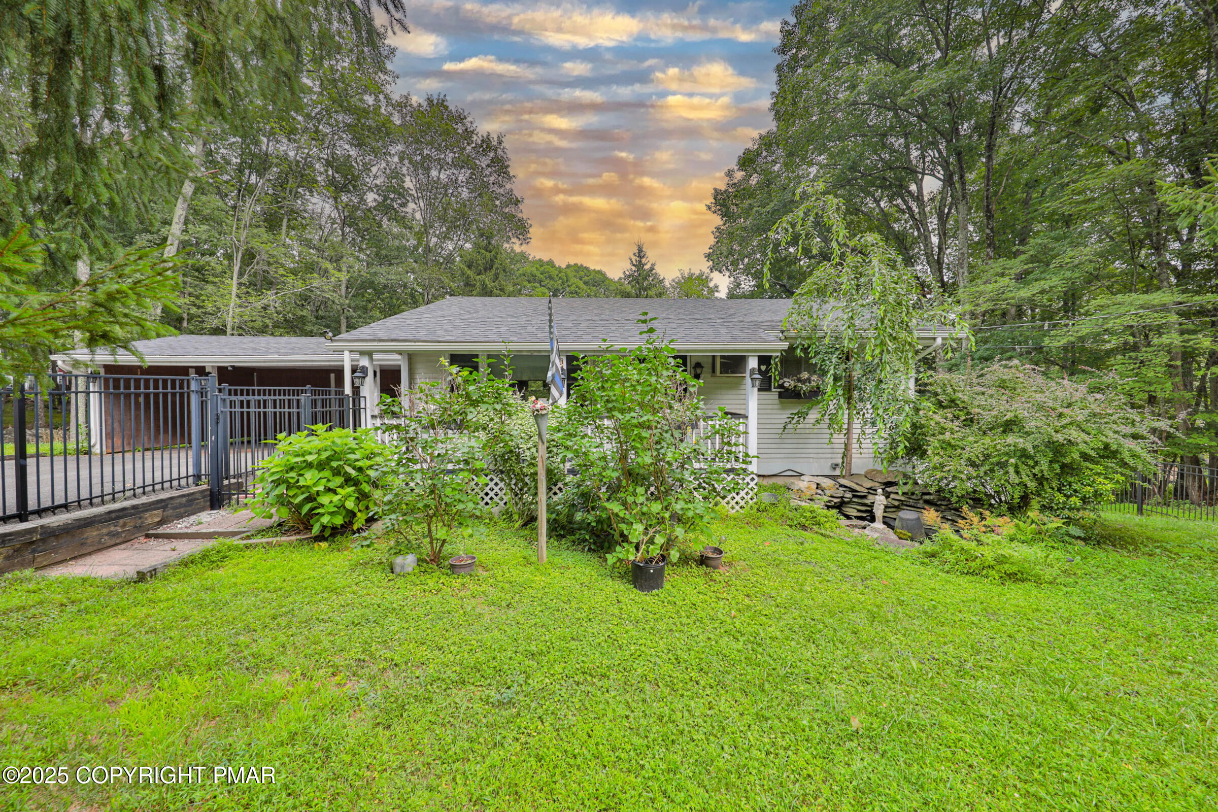 a view of a house with a yard and sitting area