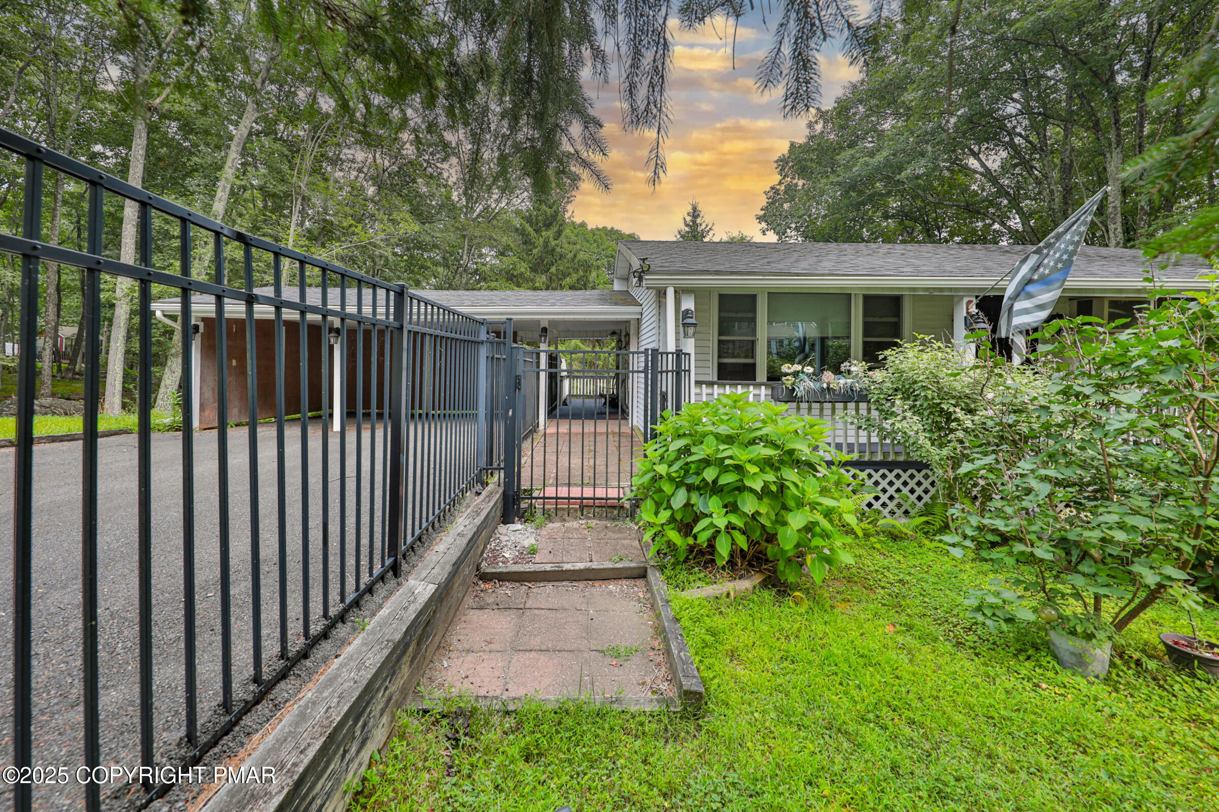 1094 Maple Lake Drive Bushkill, PA 18324 - Photo 4 of 81 a view of a house with a small yard and flower plants