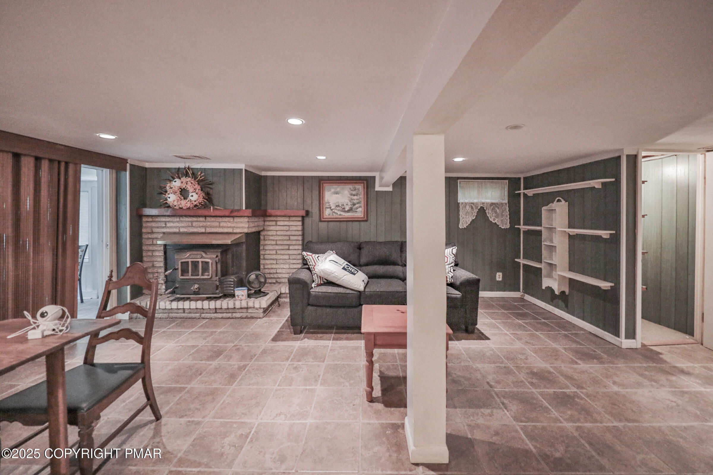 1094 Maple Lake Drive Bushkill, PA 18324 - Photo 42 of 81 a living room with furniture a fireplace and a view of kitchen