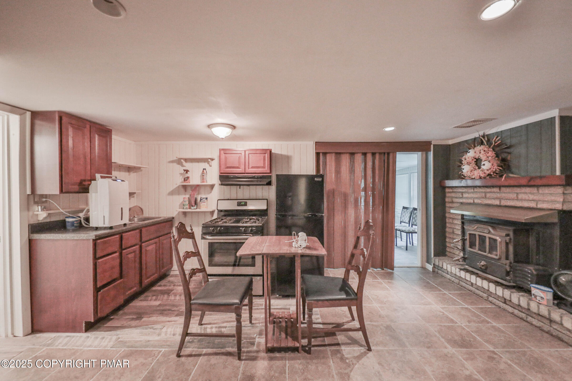 1094 Maple Lake Drive Bushkill, PA 18324 - Photo 50 of 81 a kitchen with stainless steel appliances kitchen island granite countertop a table chairs stove a refrigerator and cabinets