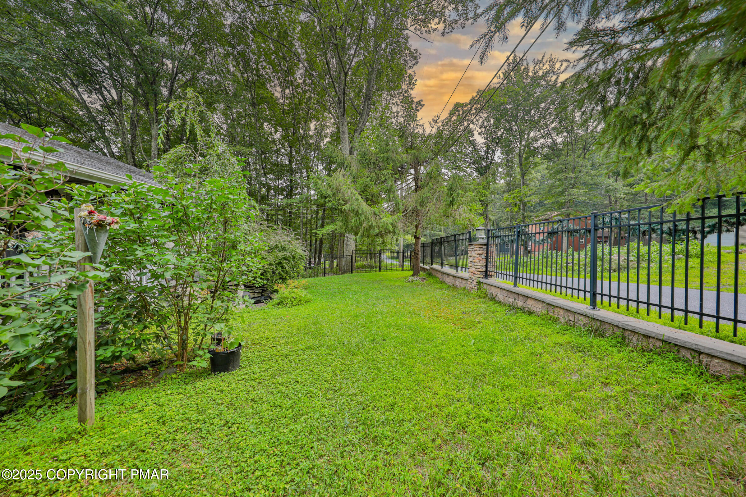 1094 Maple Lake Drive Bushkill, PA 18324 - Photo 5 of 81 a view of a backyard with a small trees