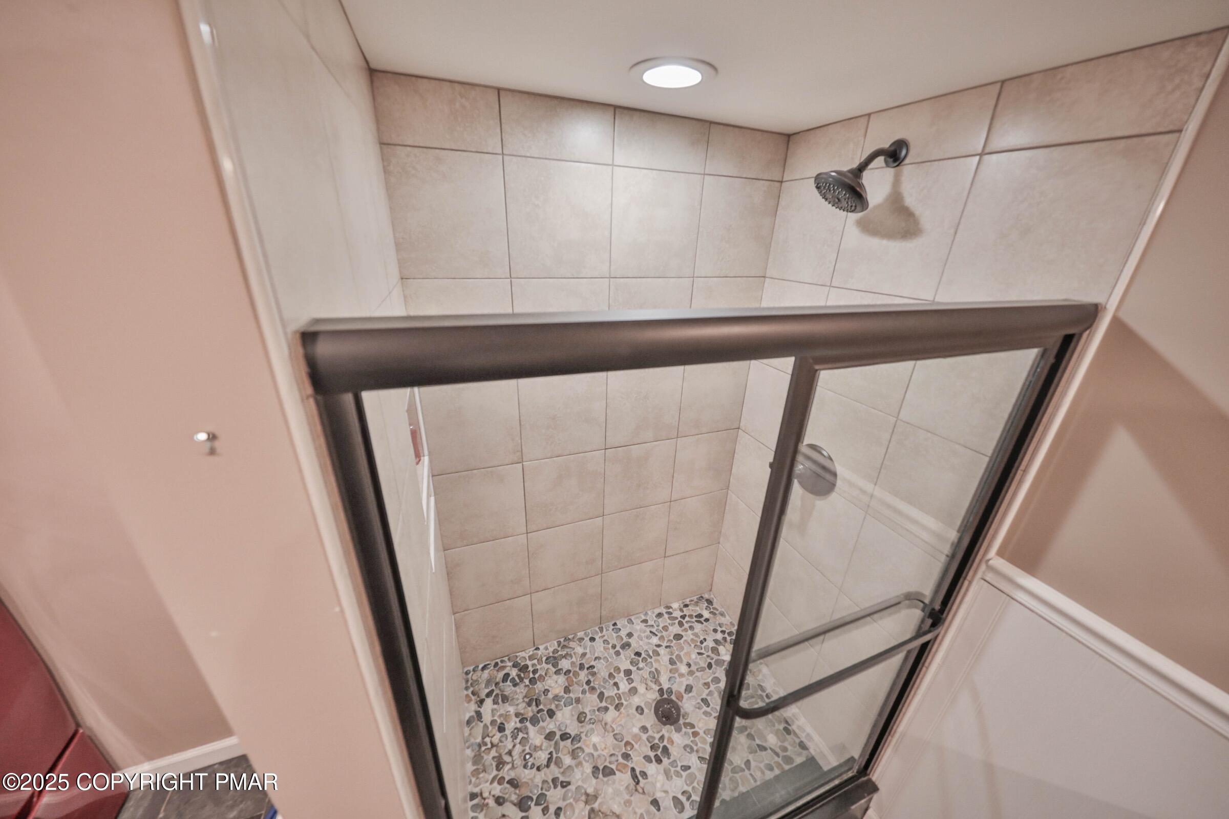 1094 Maple Lake Drive Bushkill, PA 18324 - Photo 56 of 81 a bathroom with a shower and a mirror