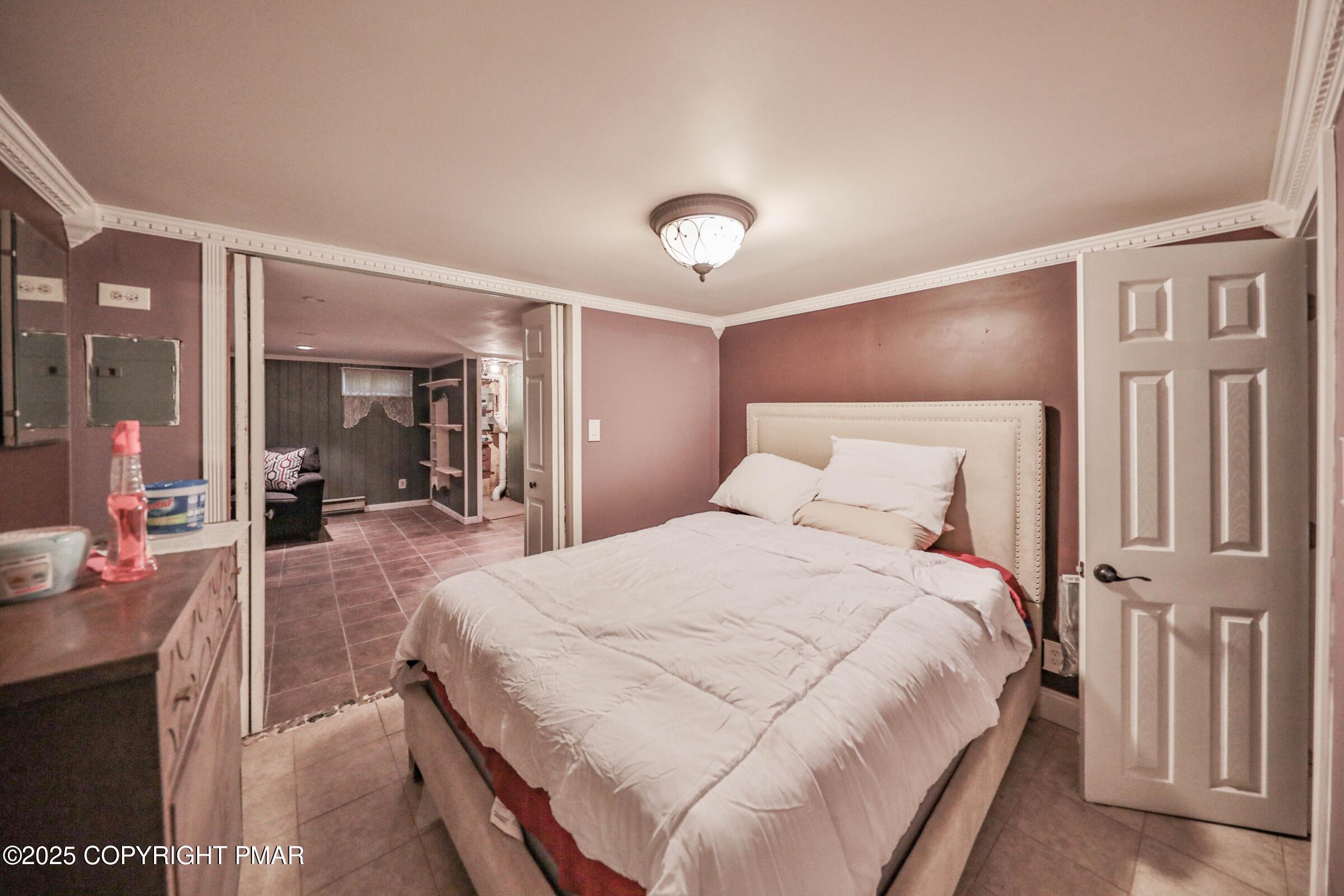 1094 Maple Lake Drive Bushkill, PA 18324 - Photo 60 of 81 a bedroom with a large bed and a large mirror