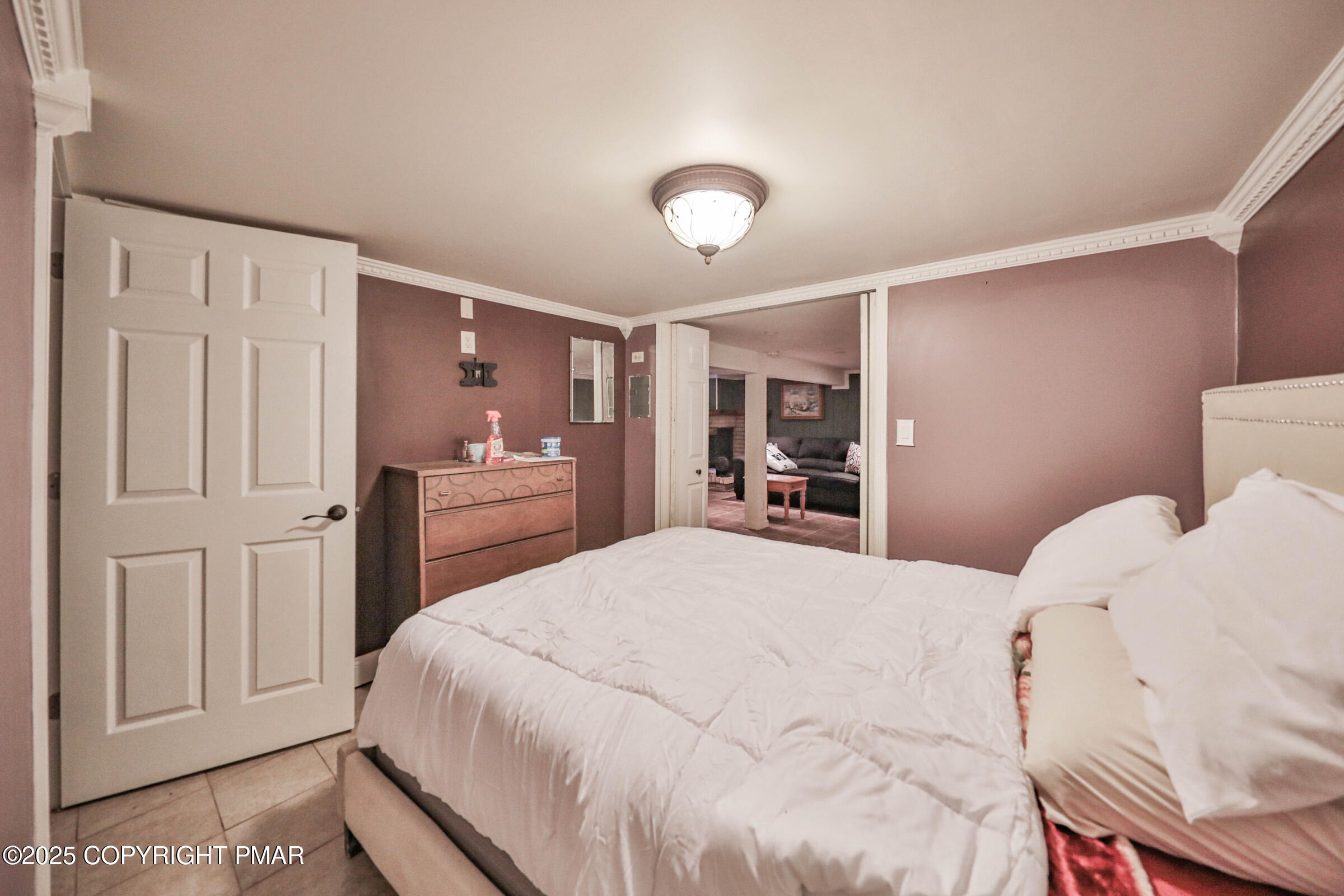 1094 Maple Lake Drive Bushkill, PA 18324 - Photo 62 of 81 a bedroom with a bed and a refrigerator