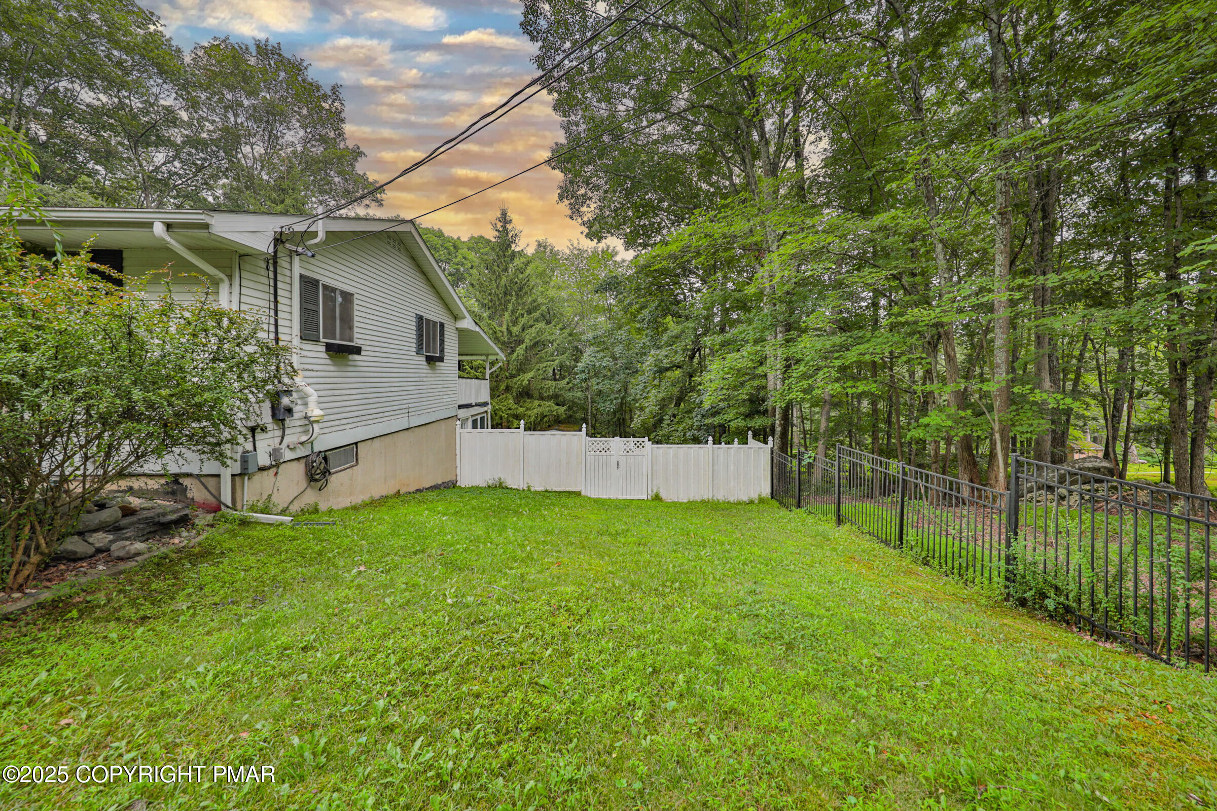 1094 Maple Lake Drive Bushkill, PA 18324 - Photo 7 of 81 a view of a backyard with a small cabin