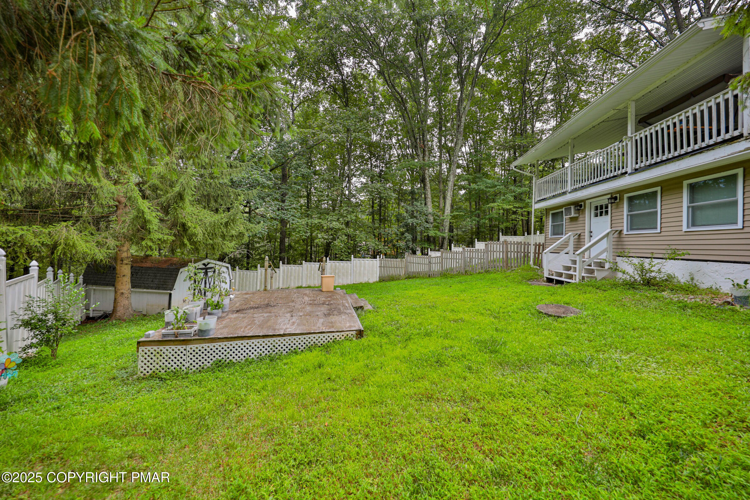 1094 Maple Lake Drive Bushkill, PA 18324 - Photo 76 of 81 a view of a house with a yard porch and sitting area