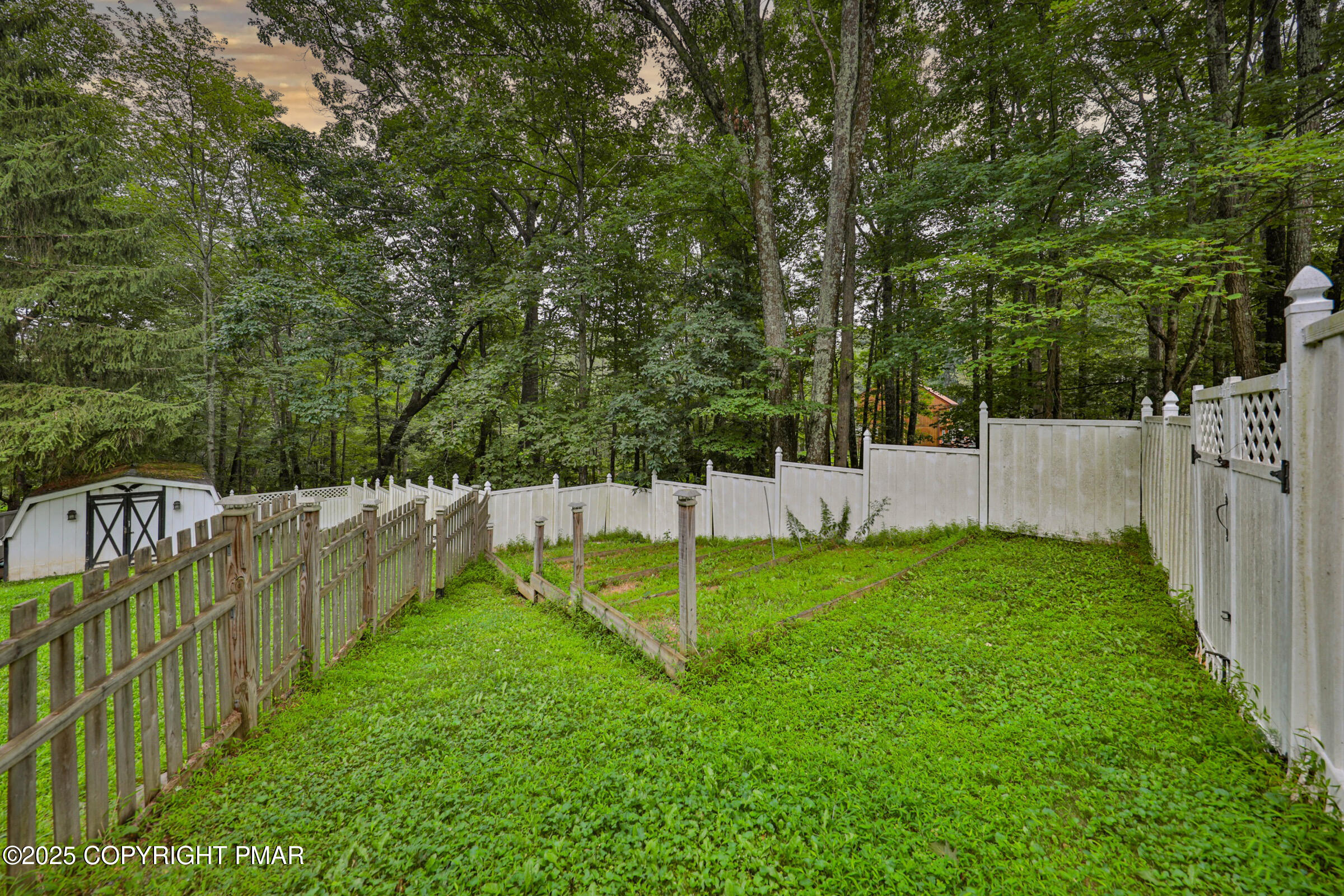 1094 Maple Lake Drive Bushkill, PA 18324 - Photo 77 of 81 a view of a backyard with wooden fence