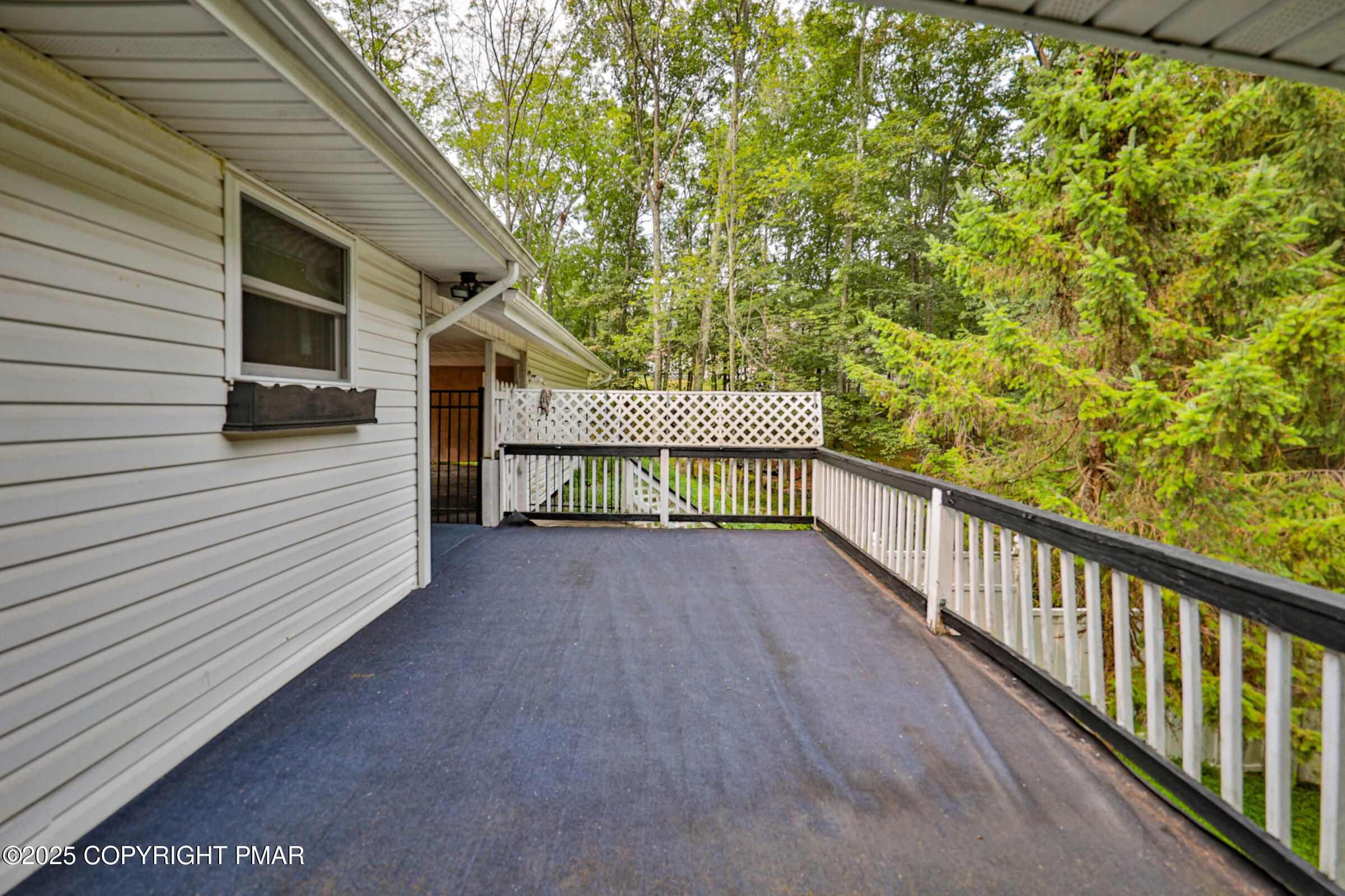 1094 Maple Lake Drive Bushkill, PA 18324 - Photo 80 of 81 a view of a wooden deck and a backyard