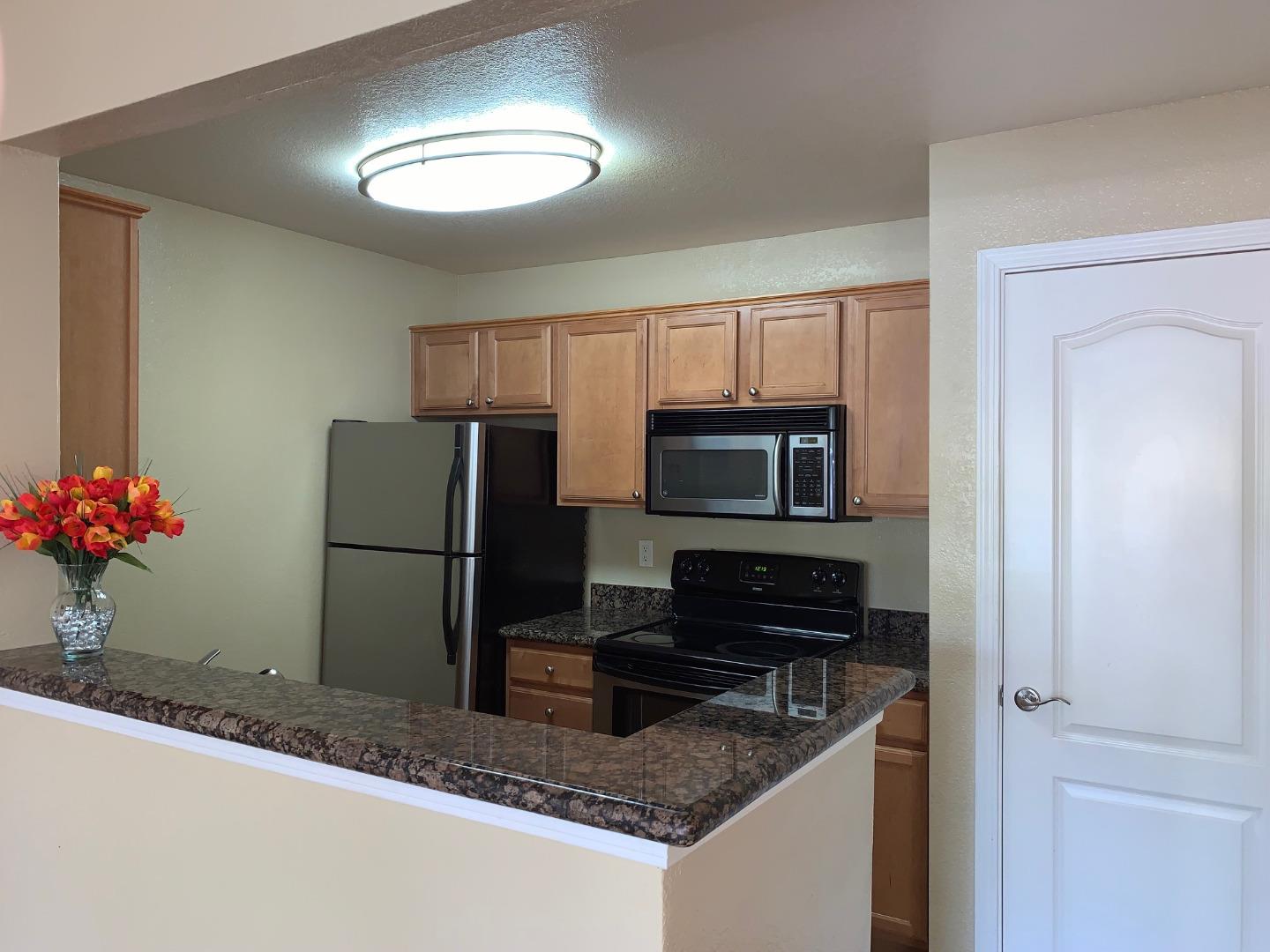 a kitchen with a refrigerator sink and microwave