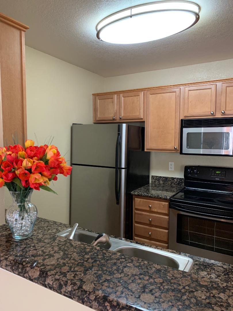105 Reflections Drive, Unit 15 San Ramon, CA 94583 - Photo 21 of 42 a kitchen with stainless steel appliances granite countertop a refrigerator cabinets and stove