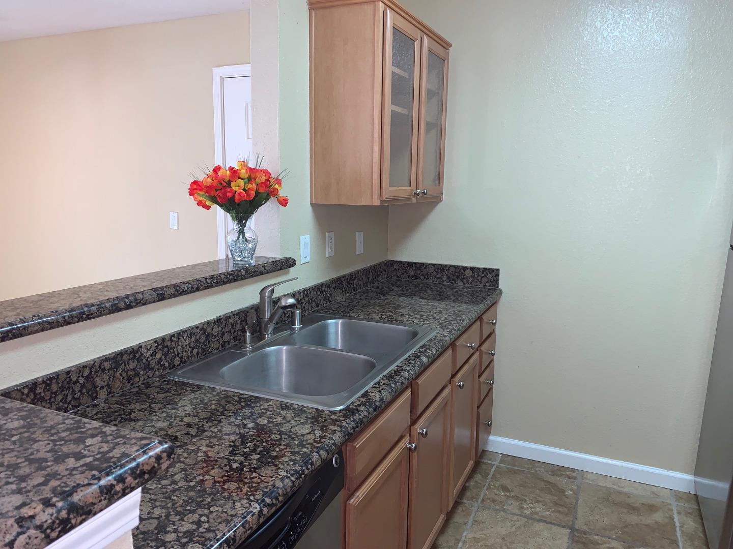 105 Reflections Drive, Unit 15 San Ramon, CA 94583 - Photo 24 of 42 a kitchen with granite countertop a sink and cabinets