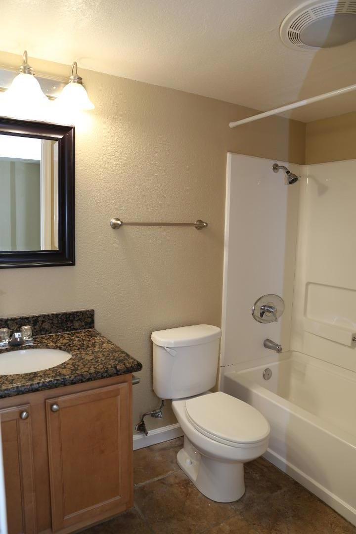 105 Reflections Drive, Unit 15 San Ramon, CA 94583 - Photo 25 of 42 a bathroom with a granite countertop toilet sink and mirror